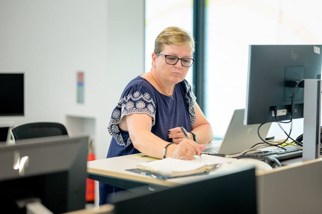 A businesswoman managing project invoicing on a computer